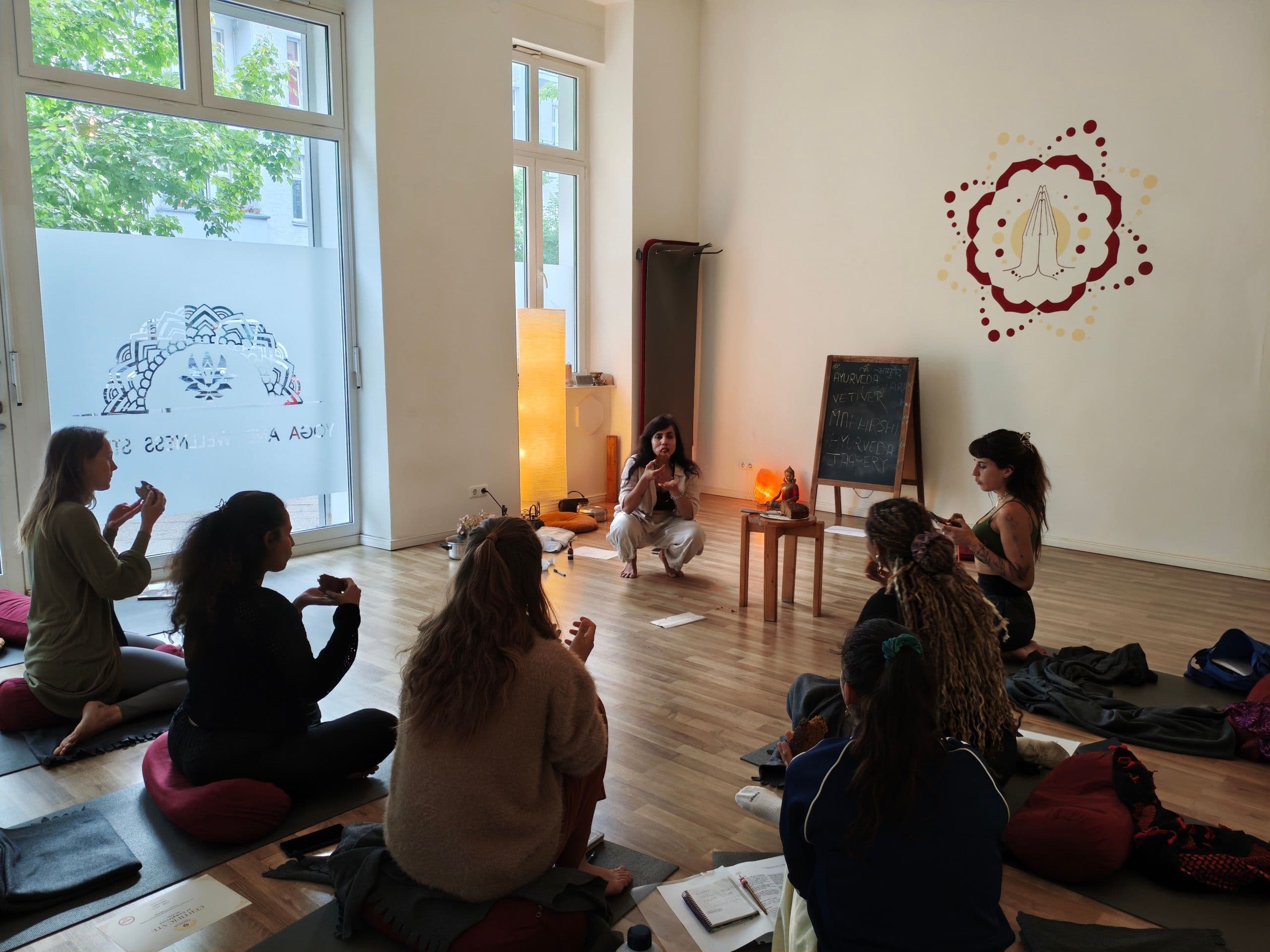 A guided seated group practice during an Ayurveda workshop at the Yogicescape studio